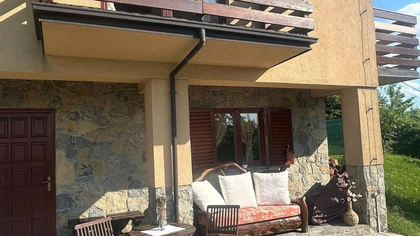 Covered patio with a sofa under the balcony