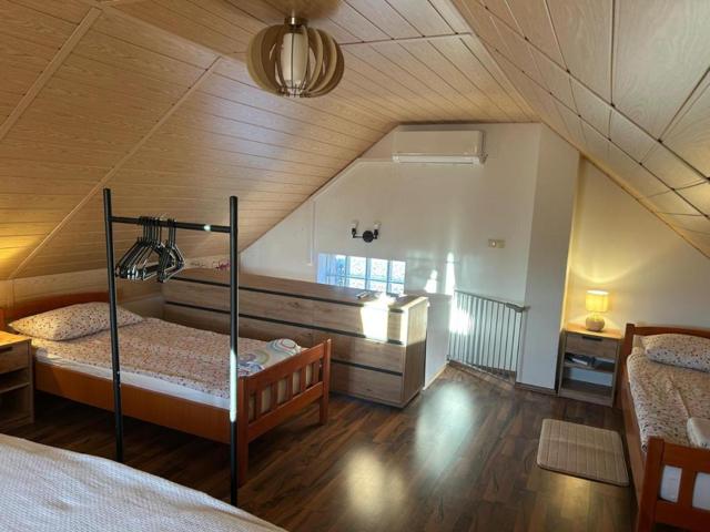 Attic bedroom with two single beds and air conditioning