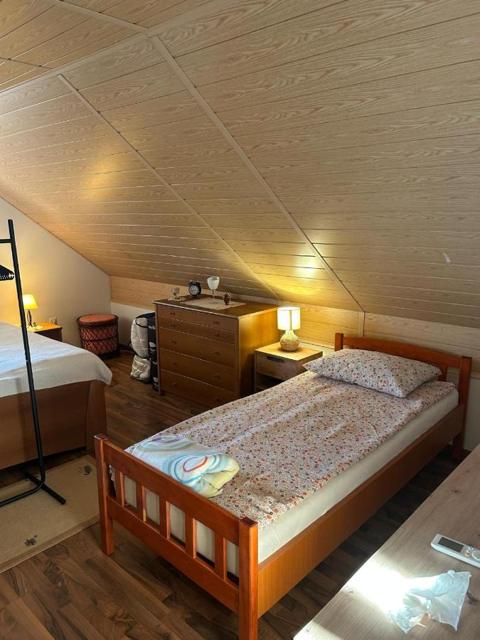 Attic bedroom with a single bed under a timber ceiling