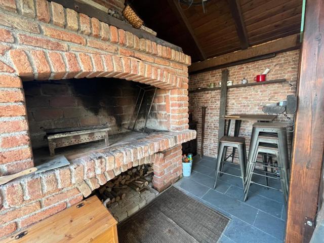 Covered brick grill with bar stools