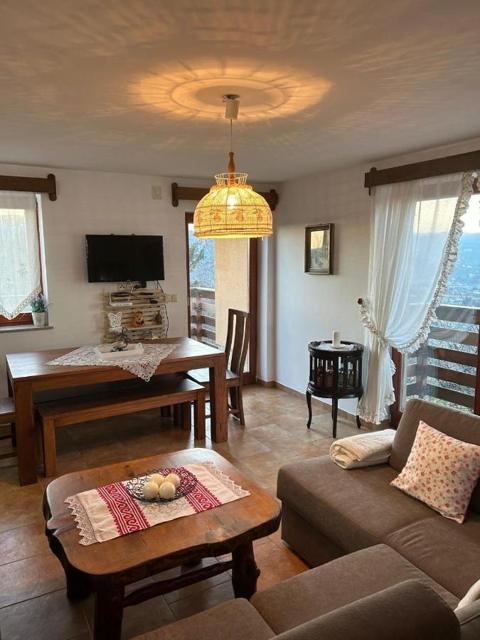 Living room with sofa, TV and dining table