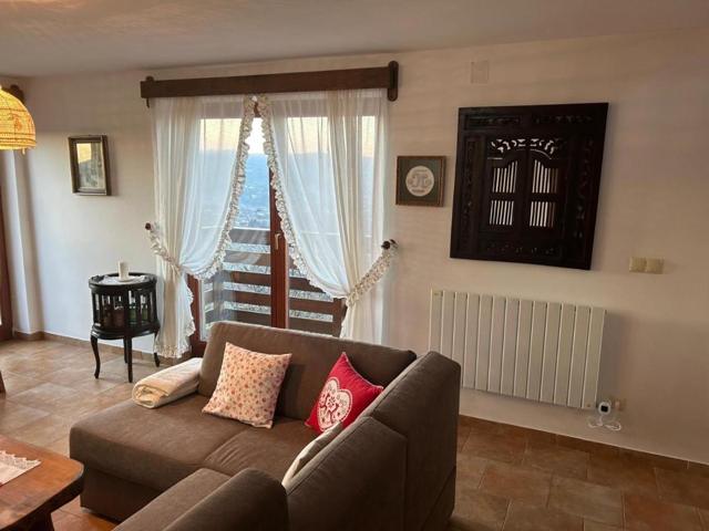 Brown sofa with cushions by the balcony window
