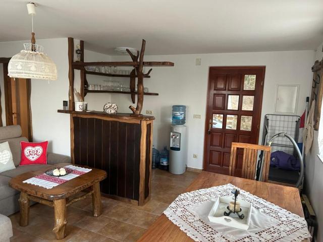 Living room with wooden bar counter and front door