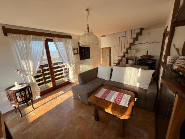 Living room with sofa, coffee table and doors open to the balcony