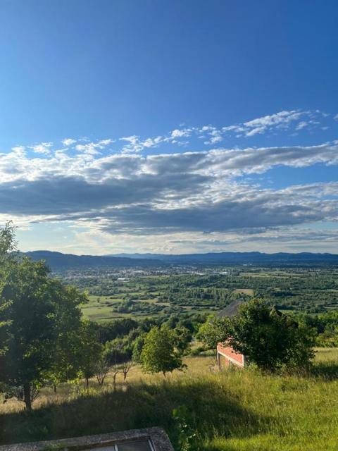 Green hills and valley under a blue sky