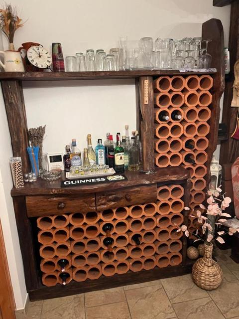 Wine rack of terracotta pipes and a drinks shelf